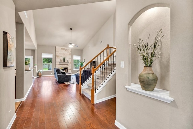 18003 Linkhill Dr, Dripping Springs, TX 78620 - entrance foyer featuring hardwood / wood-style flooring, a large fireplace, stairs, baseboards, and a ceiling fan
