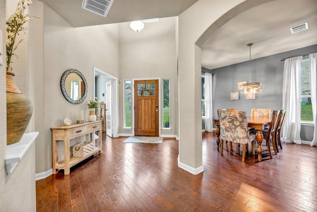 18003 Linkhill Dr, Dripping Springs, TX 78620 - entrance foyer with arched walkways, hardwood / wood-style floors, baseboards, and a chandelier