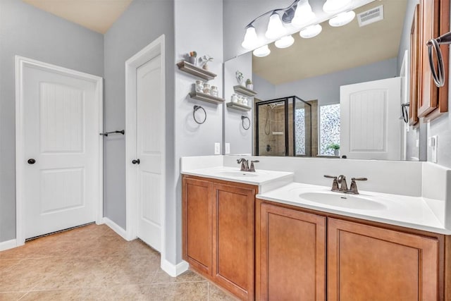 18003 Linkhill Dr, Dripping Springs, TX 78620 - full bath with a shower stall, double vanity, tile patterned flooring, and baseboards