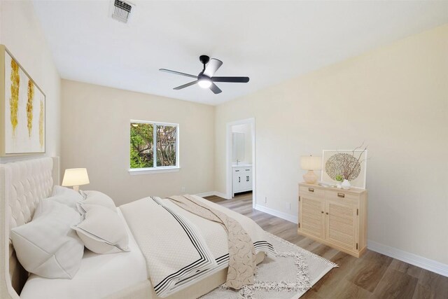 8316 Talbot Ln, Austin, TX 78746 - bedroom with light wood-type flooring, baseboards, a ceiling fan, and ensuite bathroom