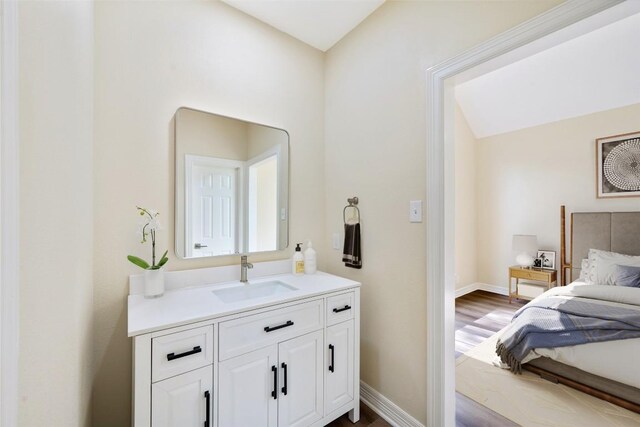 8316 Talbot Ln, Austin, TX 78746 - bathroom featuring vanity, wood finished floors, and baseboards