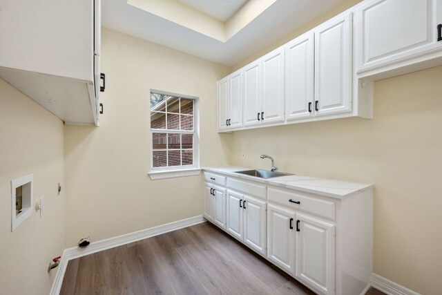 8316 Talbot Ln, Austin, TX 78746 - washroom featuring cabinet space, washer hookup, wood finished floors, baseboards, and electric dryer hookup