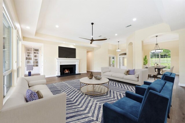 8316 Talbot Ln, Austin, TX 78746 - living area with arched walkways, wood finished floors, baseboards, a ceiling fan, and recessed lighting