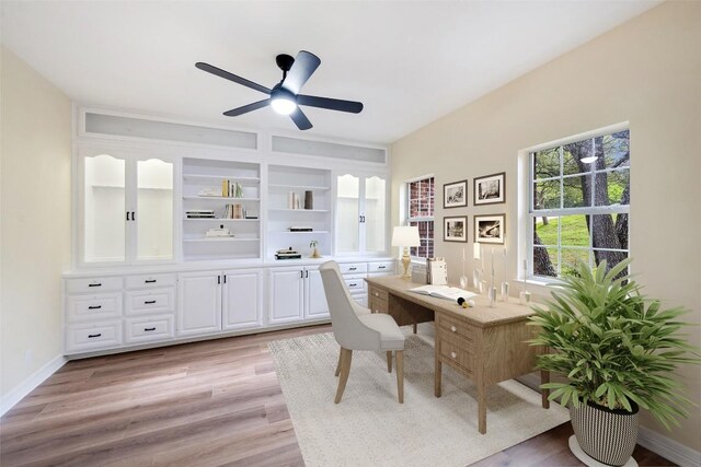 8316 Talbot Ln, Austin, TX 78746 - home office with a ceiling fan, light wood-style flooring, built in study area, and baseboards