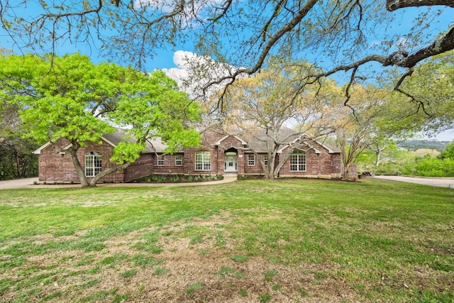8316 Talbot Ln, Austin, TX 78746 - view of front of home featuring a front lawn and brick siding