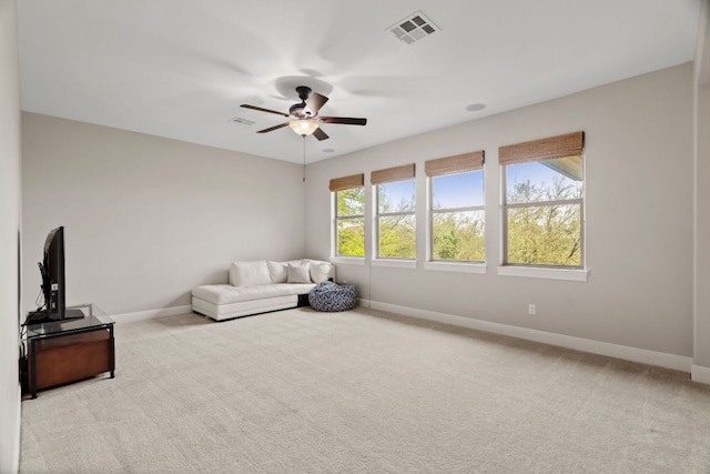 unfurnished living room featuring baseboards, a ceiling fan, visible vents, and carpet floors