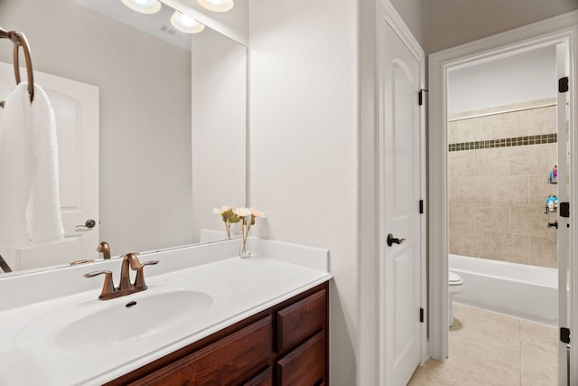 bathroom featuring toilet, vanity, and tile patterned floors