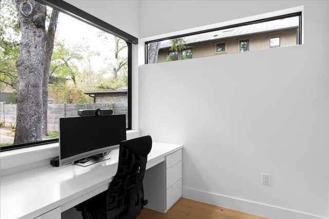 3313 Bonnie Rd, Austin, TX 78703 - office area featuring light wood-style floors, built in study area, and baseboards