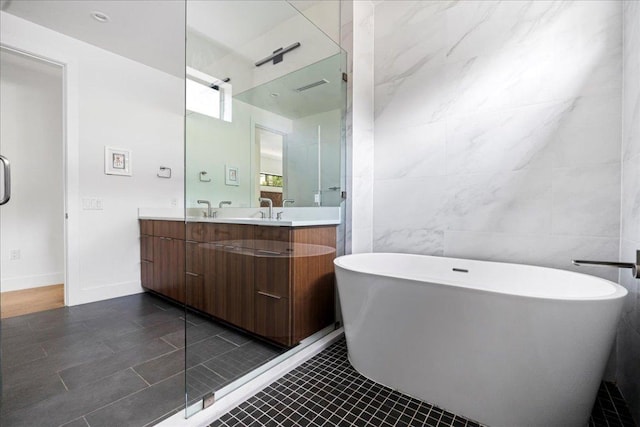 3313 Bonnie Rd, Austin, TX 78703 - bathroom featuring tile walls, double vanity, a freestanding tub, and tile patterned floors