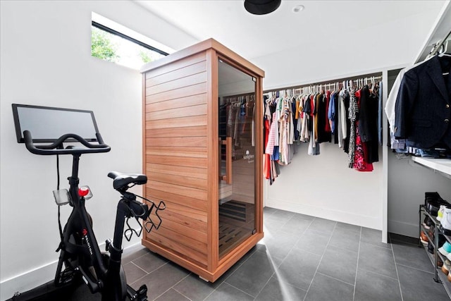 walk in closet featuring dark tile patterned flooring