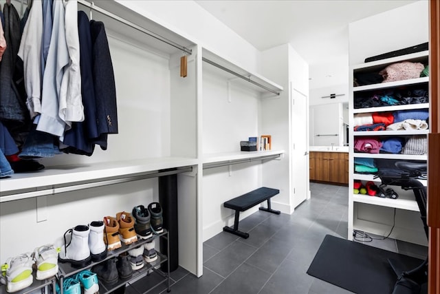 spacious closet featuring dark tile patterned flooring