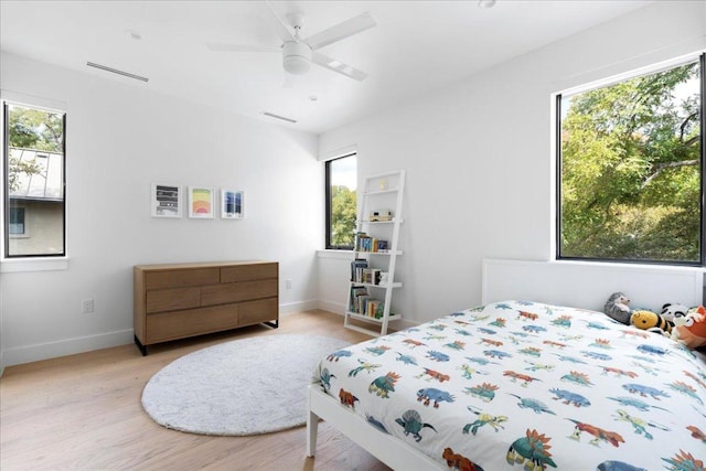 bedroom with visible vents, baseboards, light wood-type flooring, and ceiling fan