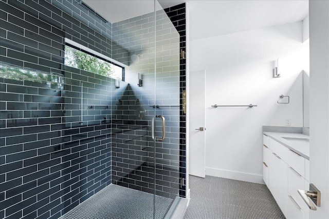 bathroom featuring a shower stall, tile patterned floors, vanity, and baseboards