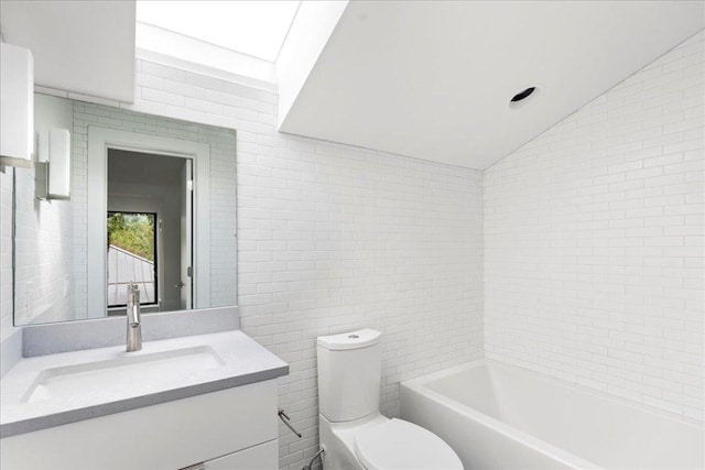 full bathroom with toilet, vanity, vaulted ceiling, and tile walls
