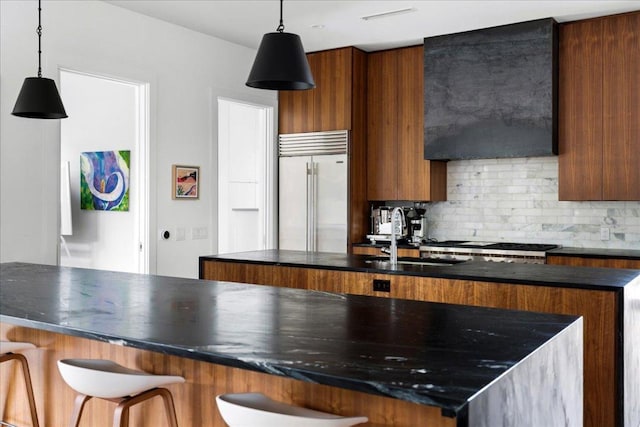 3313 Bonnie Rd, Austin, TX 78703 - kitchen with stainless steel appliances, a sink, modern cabinets, backsplash, and brown cabinets