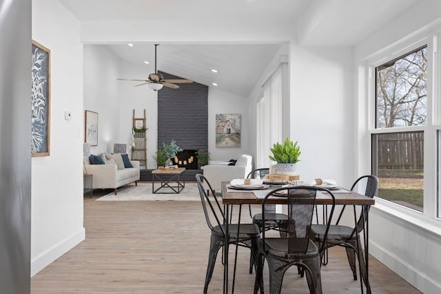 dining area with baseboards, vaulted ceiling, wood finished floors, ceiling fan, and recessed lighting