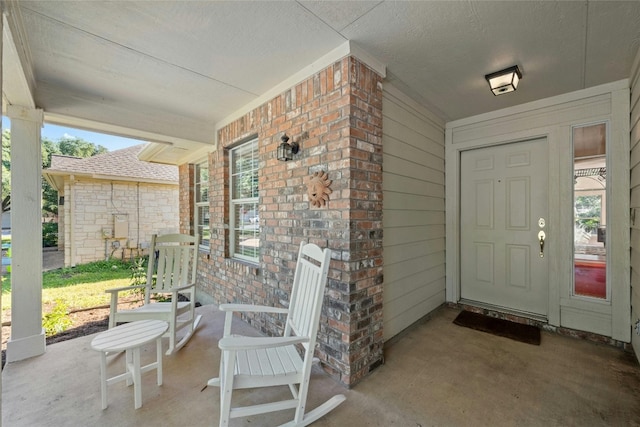 5216 Trading Bnd, Austin, TX 78735 - view of exterior entry featuring a porch and brick siding