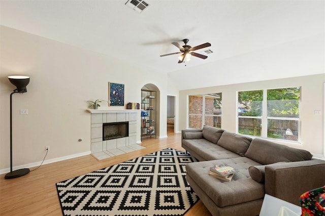 5216 Trading Bnd, Austin, TX 78735 - living room featuring a ceiling fan, arched walkways, wood finished floors, and a fireplace