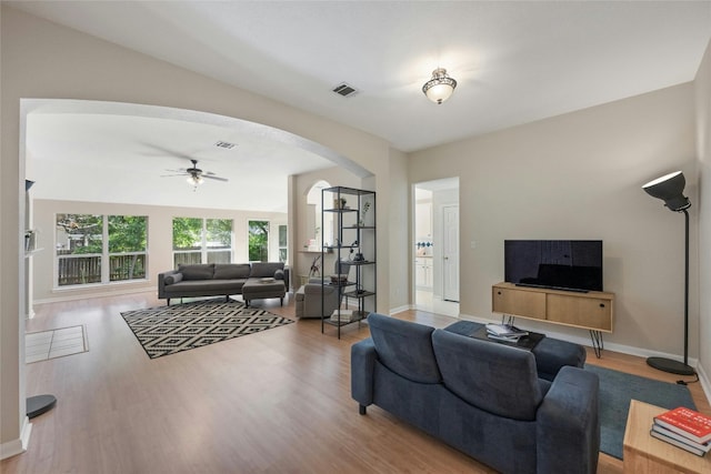 5216 Trading Bnd, Austin, TX 78735 - living area featuring arched walkways, wood finished floors, and a ceiling fan