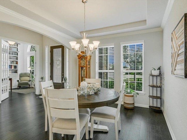 2733 Painted Sky Bnd, Leander, TX 78641 - dining space featuring a chandelier, dark wood-style flooring, a tray ceiling, and ornamental molding