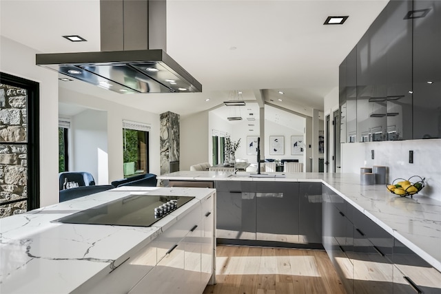 1903 Toro Canyon Rd, Austin, TX 78746 - kitchen with wall chimney range hood, modern cabinets, open floor plan, gray cabinetry, and light stone counters