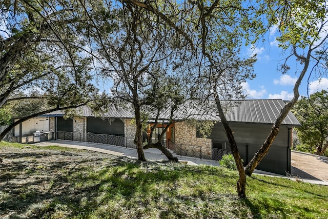 1903 Toro Canyon Rd, Austin, TX 78746 - view of front of house featuring stone siding and a metal roof