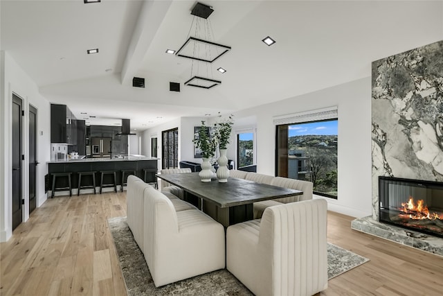1903 Toro Canyon Rd, Austin, TX 78746 - dining area featuring light wood-style floors, a premium fireplace, and recessed lighting