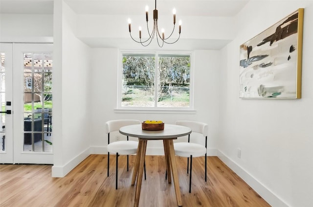 6014 London Dr, Austin, TX 78745 - dining area with a chandelier, baseboards, and wood finished floors