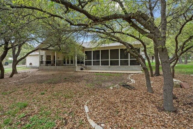 21507 Lakefront Dr, Lago Vista, TX 78645 - rear view of property featuring a sunroom