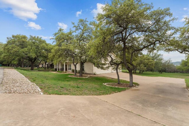21507 Lakefront Dr, Lago Vista, TX 78645 - view of front of home featuring driveway, a front lawn, and a garage
