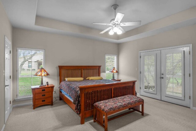 21507 Lakefront Dr, Lago Vista, TX 78645 - carpeted bedroom with access to exterior, french doors, a raised ceiling, and a ceiling fan