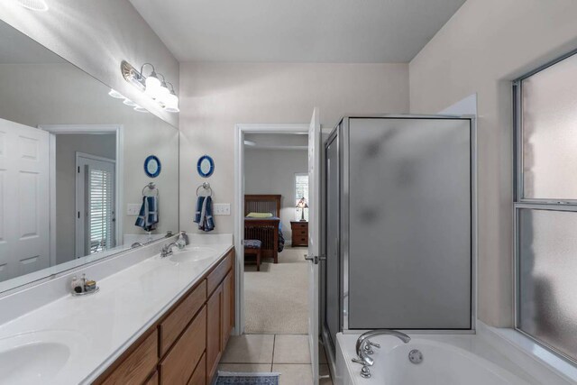 21507 Lakefront Dr, Lago Vista, TX 78645 - ensuite bathroom with double vanity, a shower stall, tile patterned flooring, and a bath