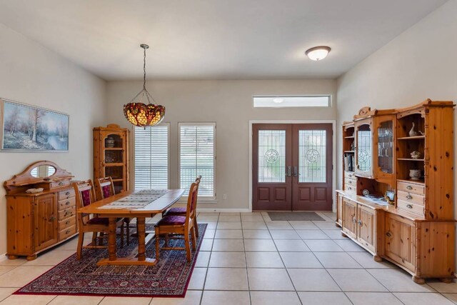 21507 Lakefront Dr, Lago Vista, TX 78645 - foyer entrance featuring french doors, light tile patterned flooring, a chandelier, and baseboards