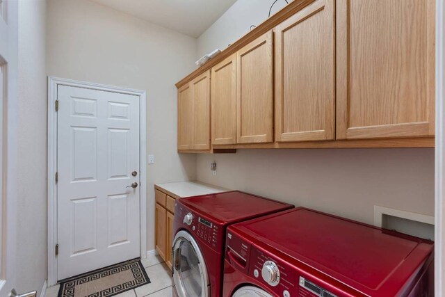 21507 Lakefront Dr, Lago Vista, TX 78645 - washroom featuring cabinet space, washing machine and clothes dryer, and light tile patterned floors