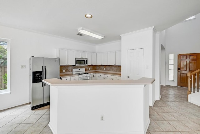 13401 Lamplight Village Ave, Austin, TX 78727 - kitchen featuring appliances with stainless steel finishes, tasteful backsplash, white cabinetry, light countertops, and ornamental molding