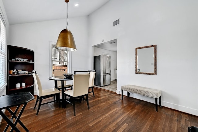 5313 Martin Ave, Austin, TX 78751 - dining area with wood finished floors, baseboards, and a high ceiling