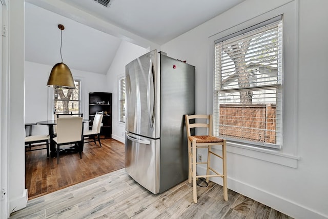 5313 Martin Ave, Austin, TX 78751 - kitchen featuring freestanding refrigerator, vaulted ceiling, light wood-style flooring, baseboards, and decorative light fixtures
