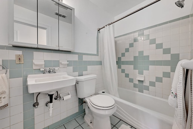 5313 Martin Ave, Austin, TX 78751 - full bath with toilet, tile walls, shower / bath combination with curtain, tile patterned floors, and wainscoting