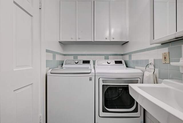 5313 Martin Ave, Austin, TX 78751 - washroom with washing machine and dryer and cabinet space