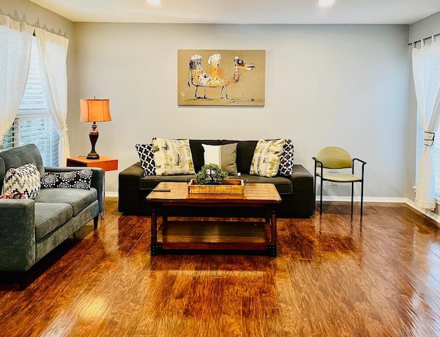 living area with baseboards, recessed lighting, and wood finished floors