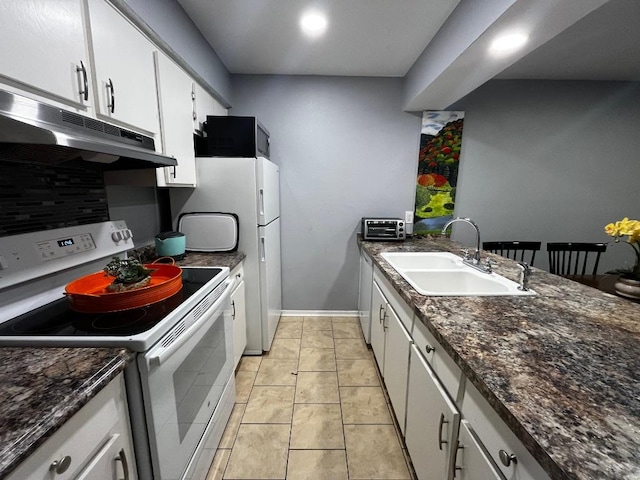 kitchen with white appliances, white cabinetry, under cabinet range hood, a sink, and decorative backsplash