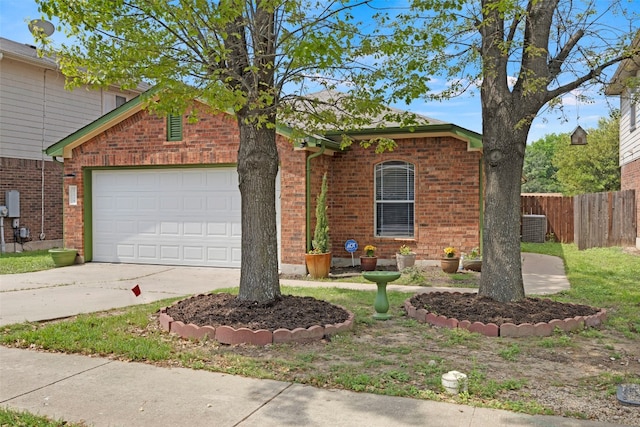 12404 Granton Cv, Austin, TX 78754 - traditional-style home with central AC unit, fence, concrete driveway, brick siding, and a garage