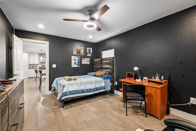 1241 Lake Terrace Dr, Elgin, TX 78621 - bedroom with light wood-style flooring, a textured wall, baseboards, and a ceiling fan