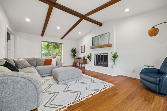 living area featuring wood finished floors, recessed lighting, a brick fireplace, and baseboards