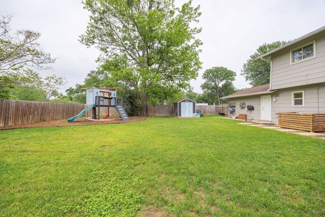 view of yard with a playground, a shed, and an outdoor structure
