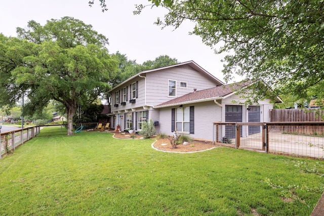 rear view of house with a gate and brick siding