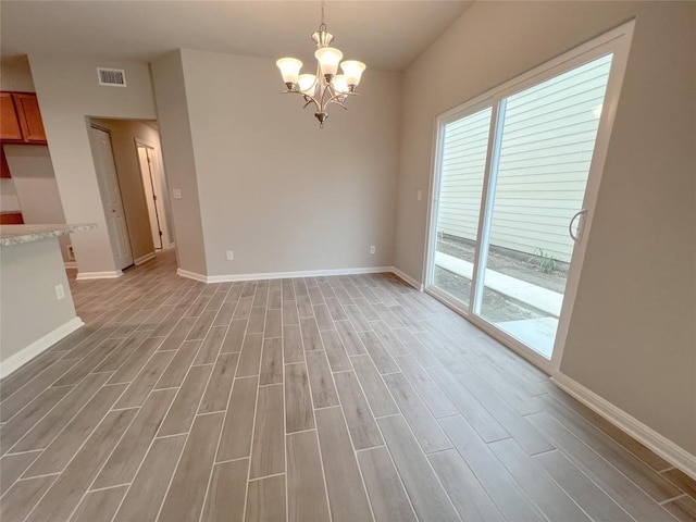 676 Ferrule Dr, Kyle, TX 78640 - unfurnished dining area with a chandelier, light wood-type flooring, and baseboards