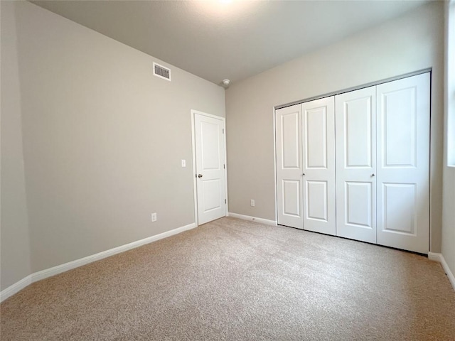 676 Ferrule Dr, Kyle, TX 78640 - unfurnished bedroom featuring light colored carpet, baseboards, and a closet