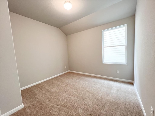 676 Ferrule Dr, Kyle, TX 78640 - carpeted empty room featuring lofted ceiling and baseboards