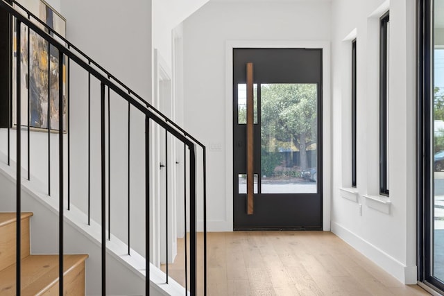 814 Stark St, Austin, TX 78756 - foyer entrance featuring light wood-style flooring, stairs, and baseboards